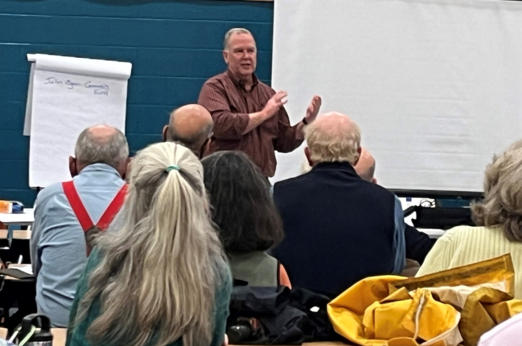 A Genesis Fund staff member addresses a community group interested in building affordable housing for their neighbors.