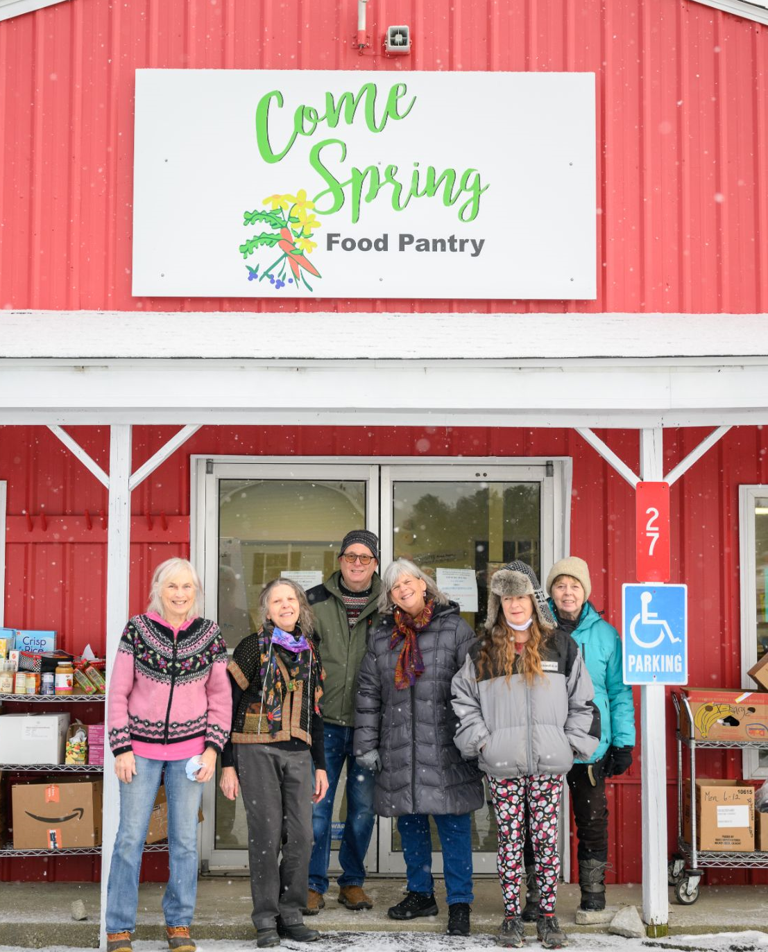 Smiling volunteers stand outside their newly renovated community food pantry in Union, Maine.