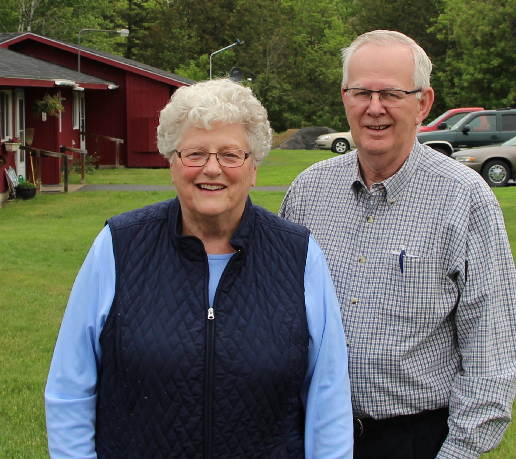 A man and his wife stand in front of their rural rental property in Aroostook County, Maine, which Genesis is helping transfer to new owners who will keep the units affordable for renters.