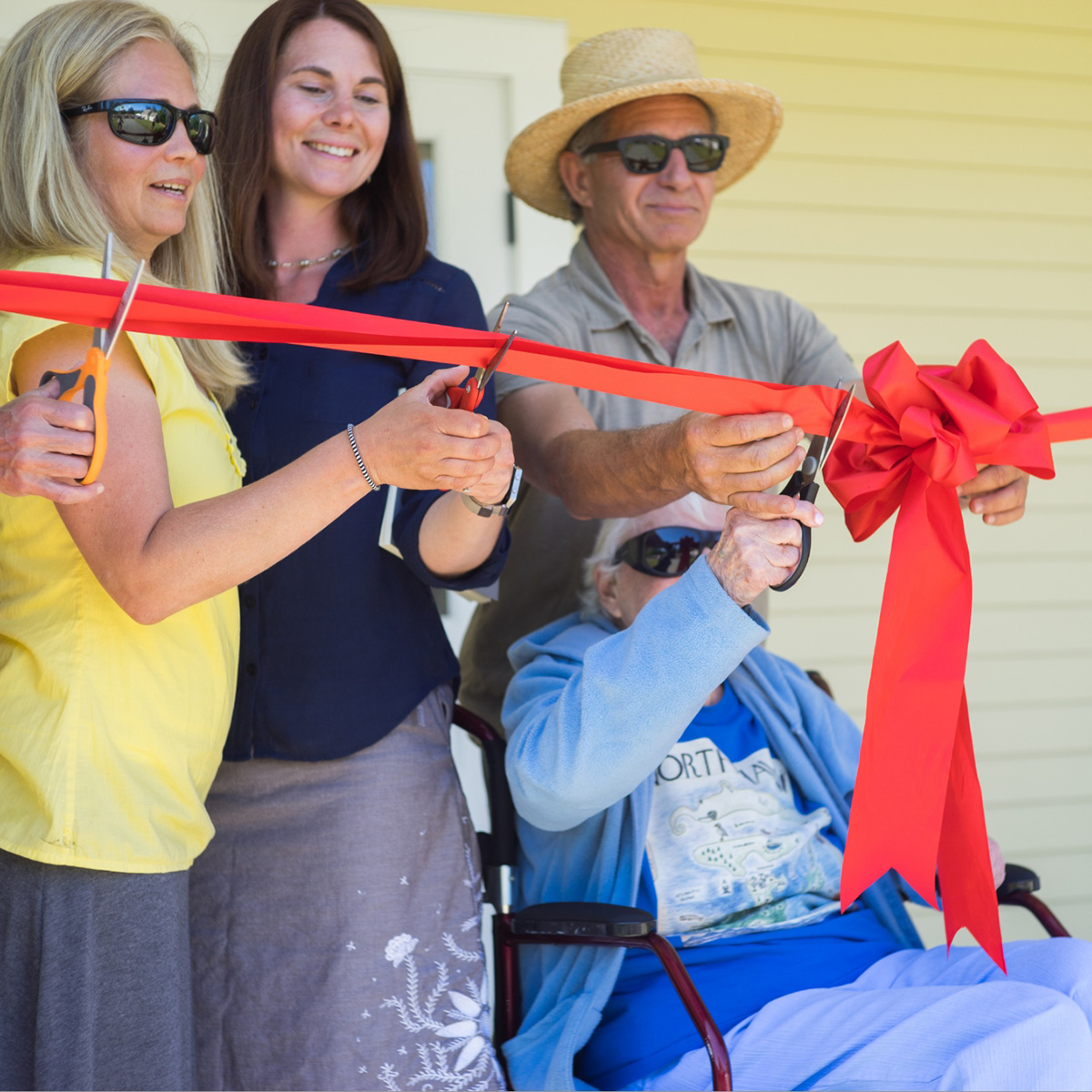 Supporters happily prepare to cut the ribbon at the grand opening of a Genesis Fund-supported senior housing facility in North Haven, Maine.