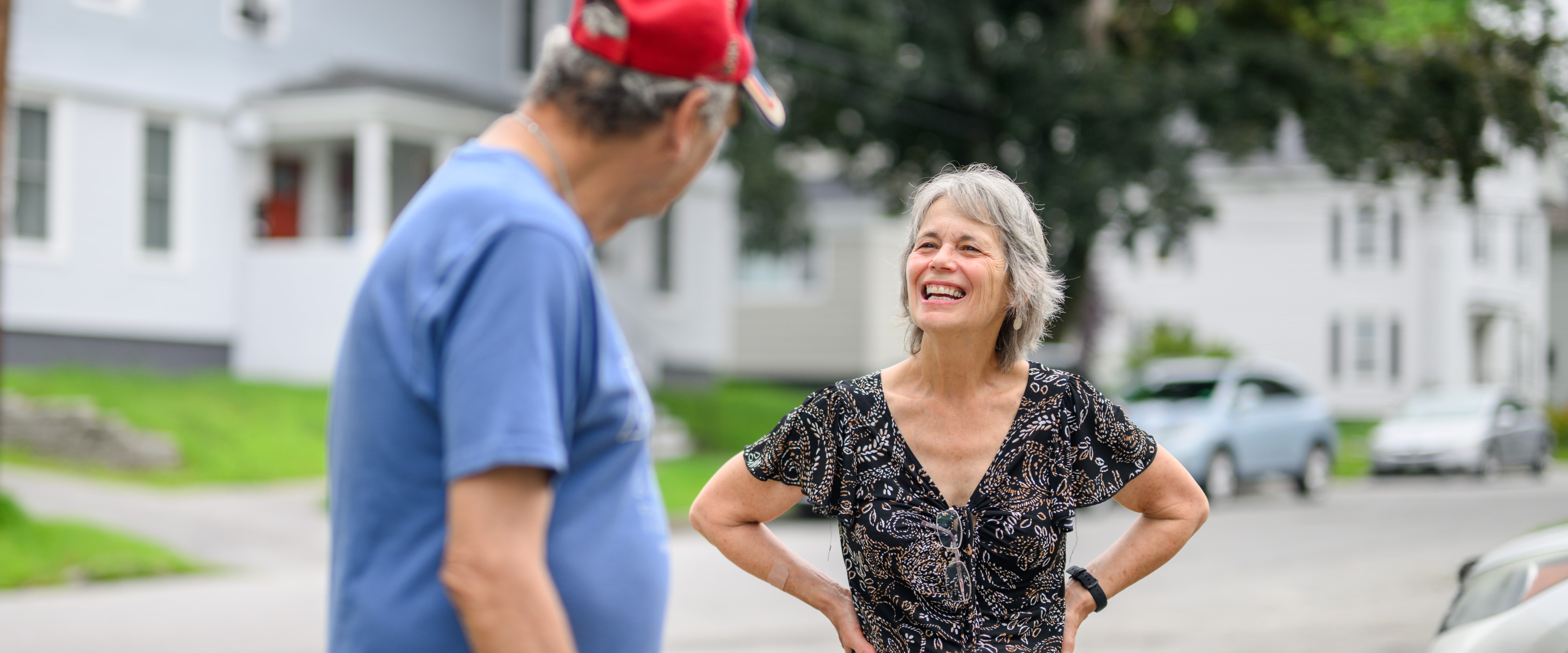 A staff member and a client share a laugh outside a homeless shelter in Brunswick, Maine.