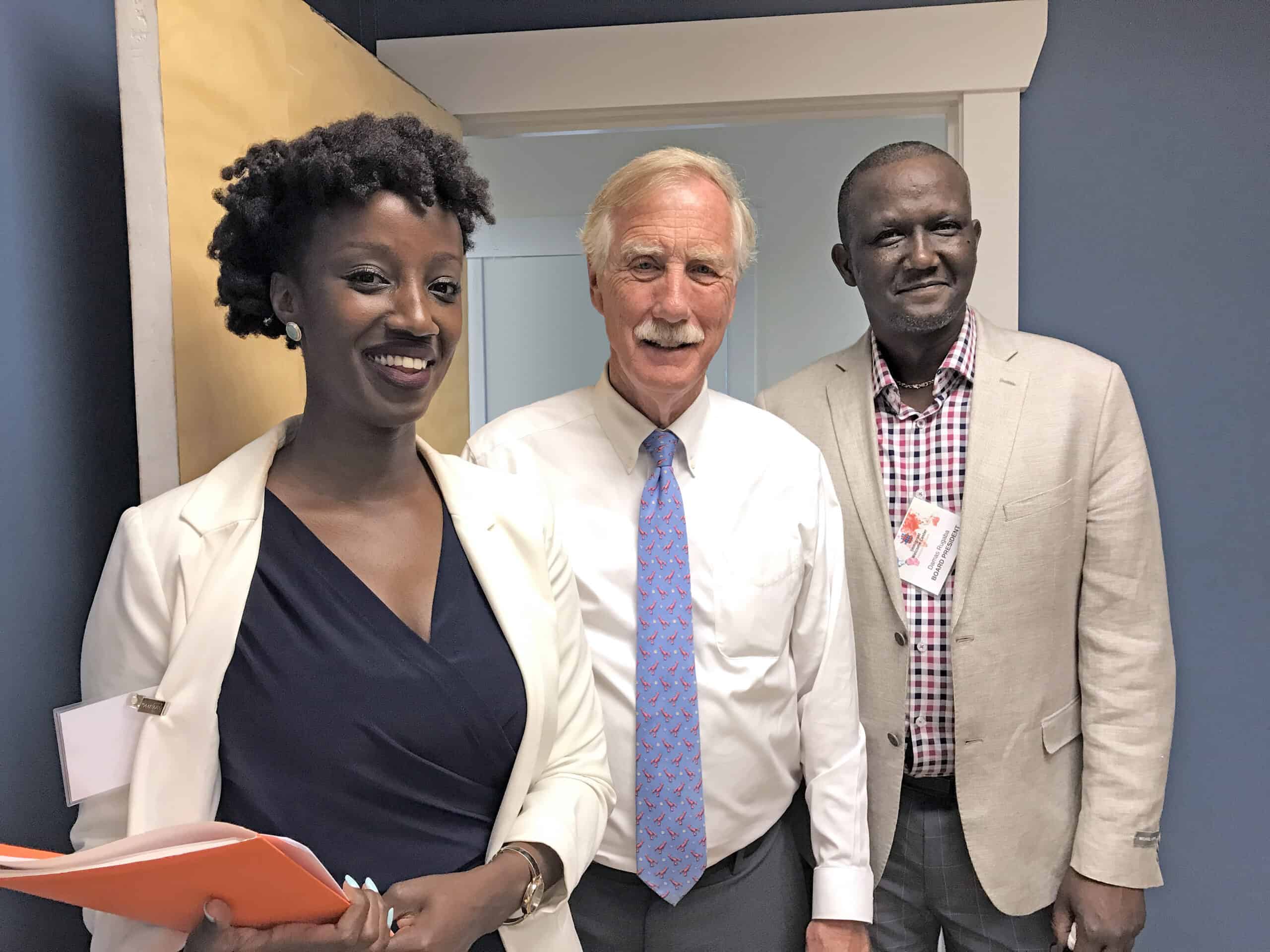 Diverse group of professionals smiling at a conference or event.