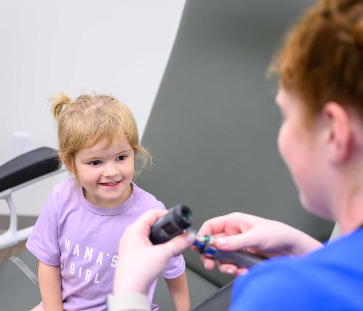 Child receiving a vaccination from a healthcare professional in a clinic setting.