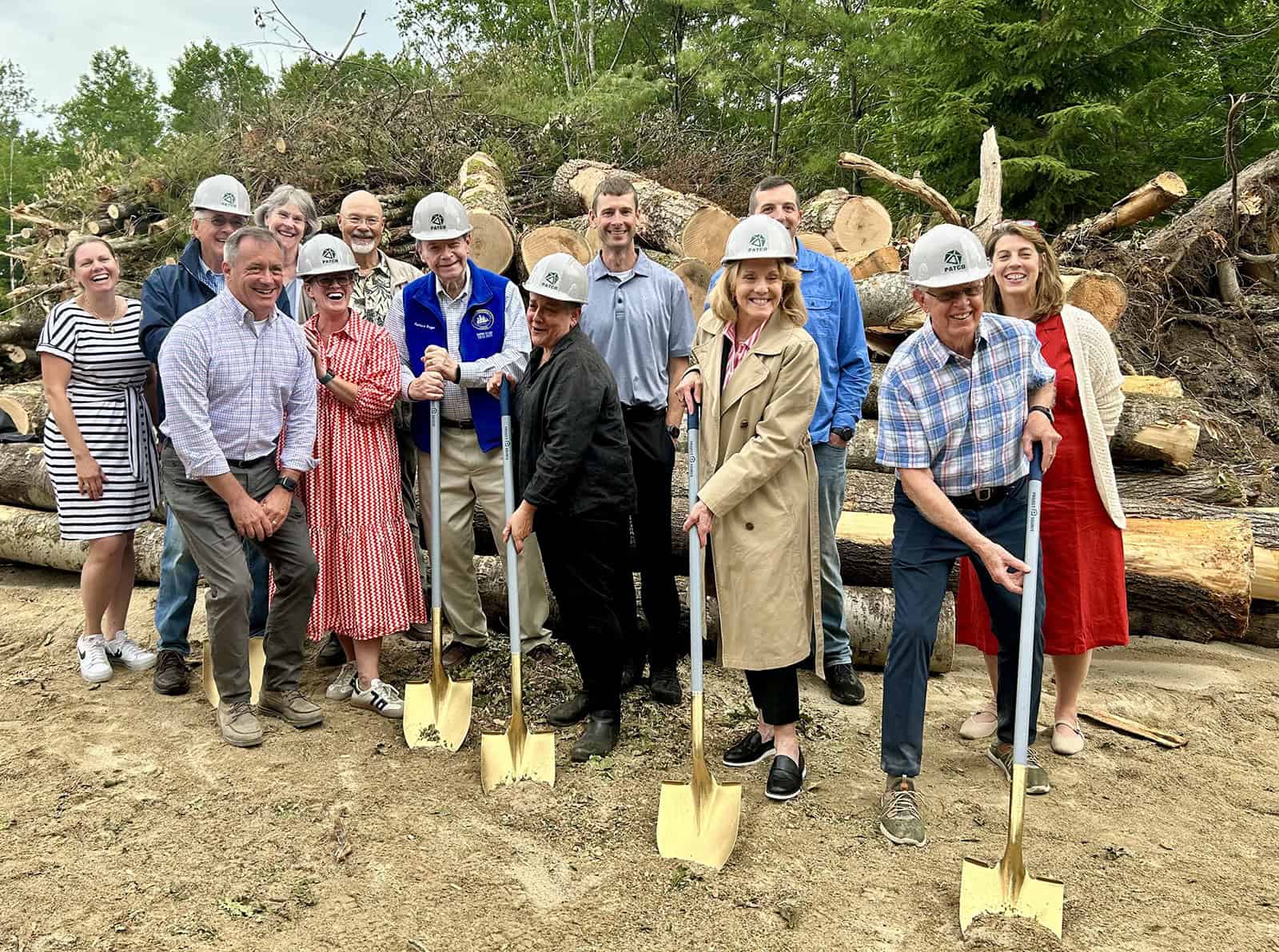 Community members at groundbreaking event for local housing project.