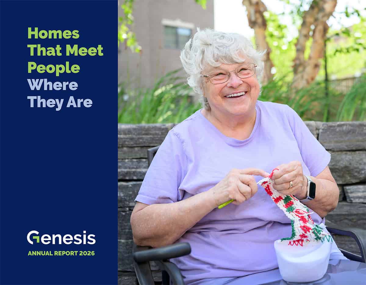 Elderly woman knitting outdoors, smiling, in a garden setting.